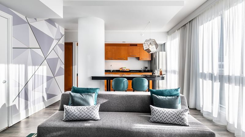 Penthouse Suite Crescent living area with dining table at Warwick Le Crystal