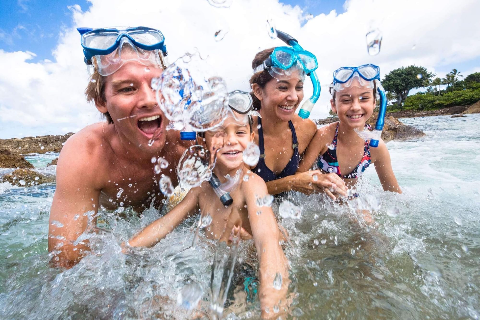 A family enjoying on the Sans Souci Beach near Waikiki Resort Hotel