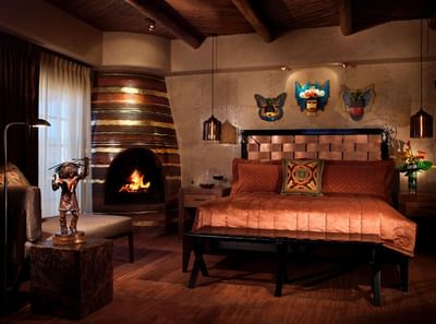 Luxurious Governor's Suite at Hilton Santa Fe Buffalo Thunder with a cozy fireplace and Mexico-inspired artwork