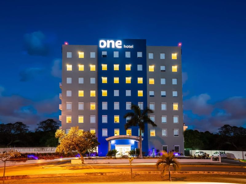 The front facade of One Cancún Centro during the night