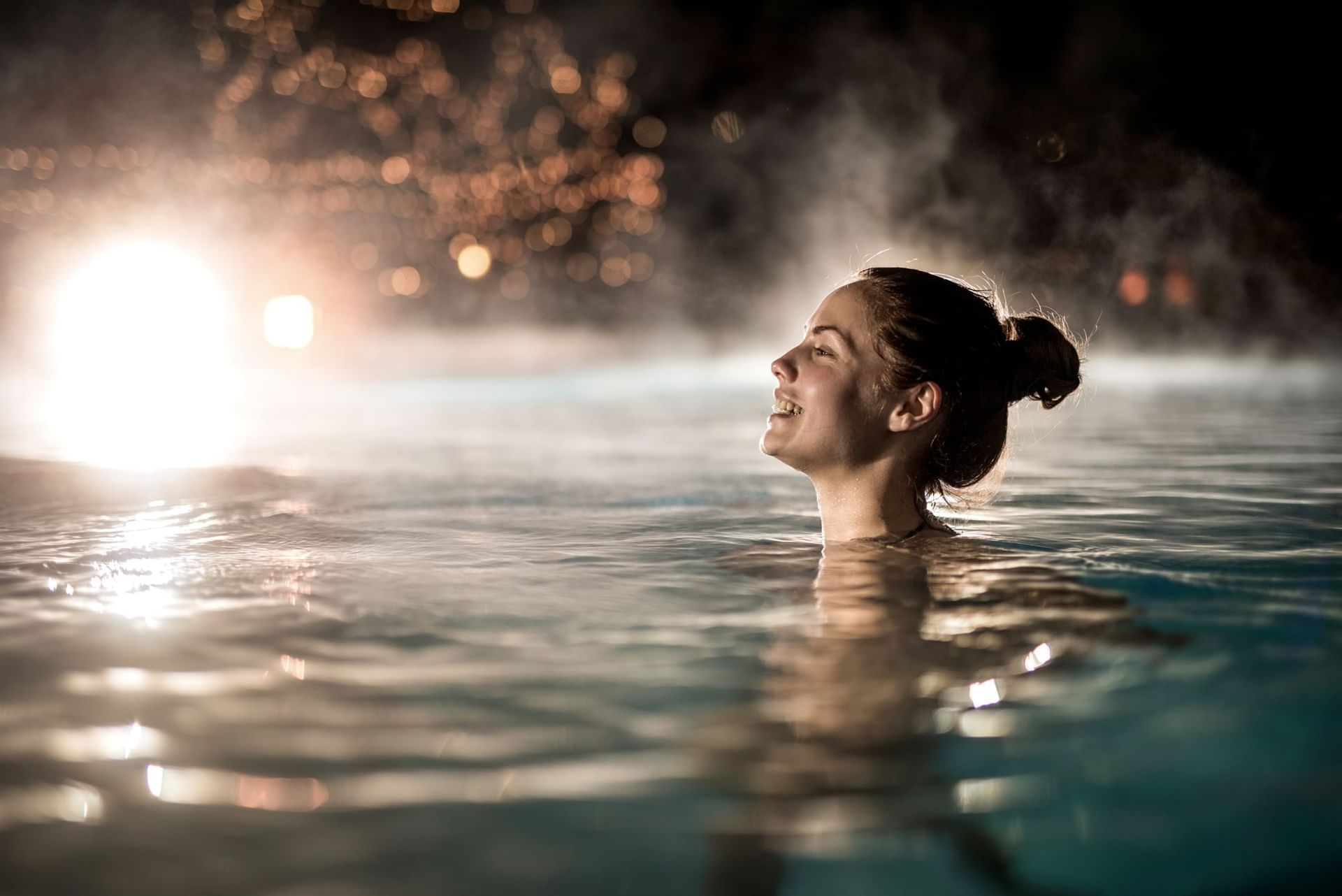 Lady in a pool, relaxing at Falkensteiner Hotels and Residences