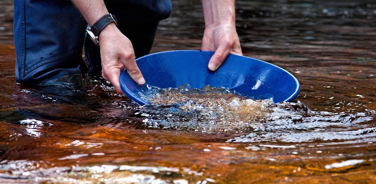 Panning for Gold in a river near Coast hotels Downtown