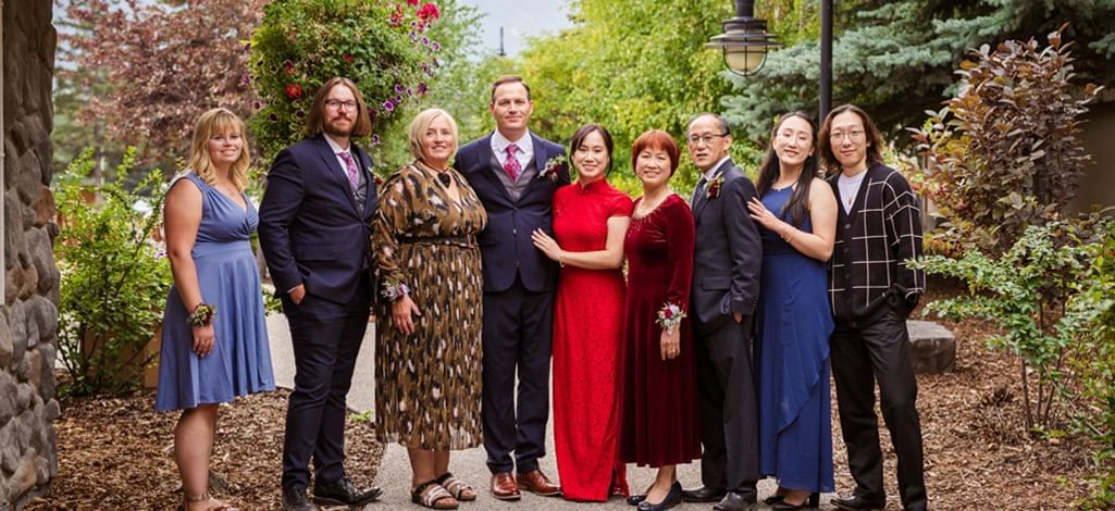 A family poses for a photo during their group travel for a wedding at a Canmore hotel.