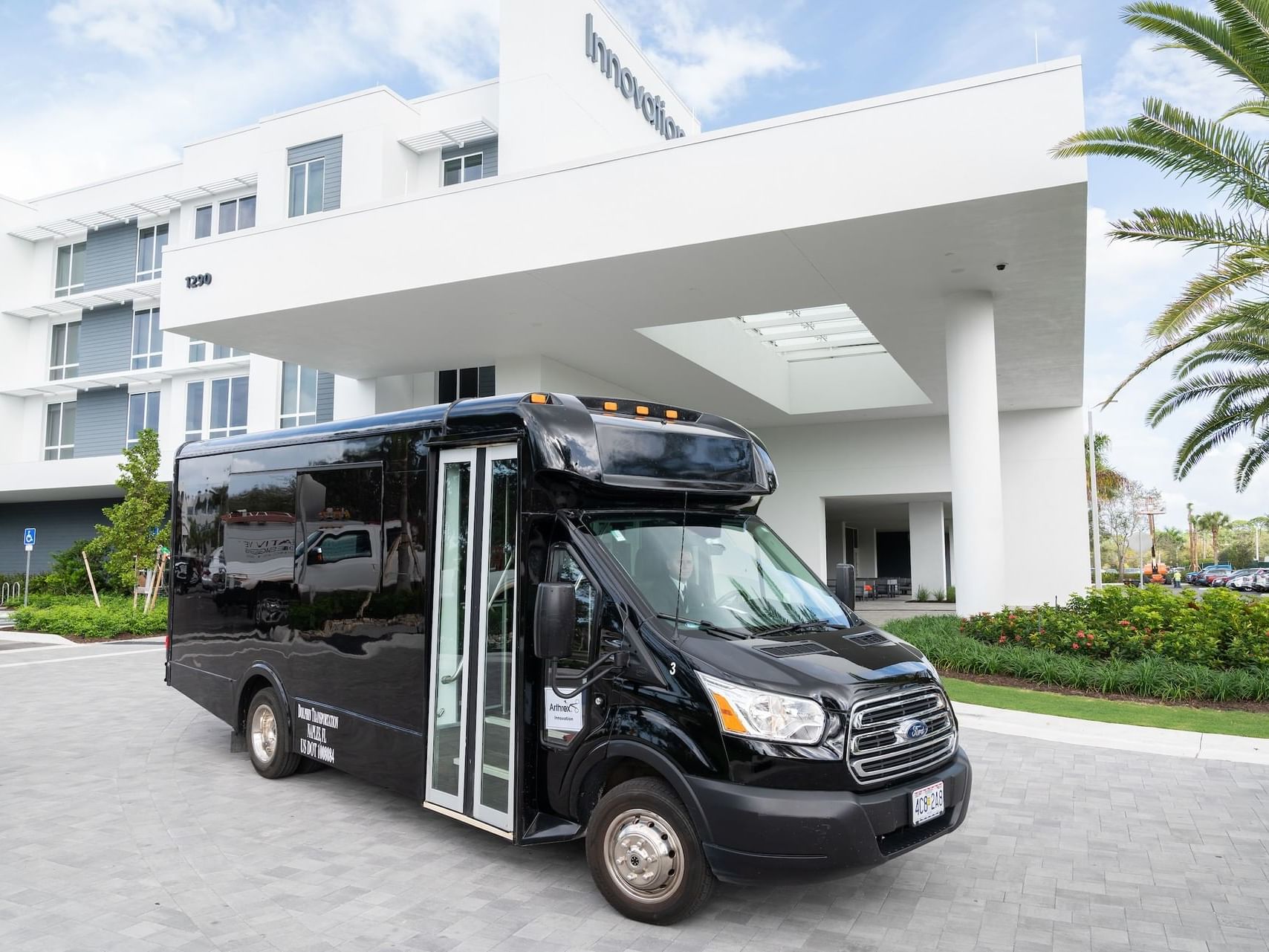 Black Ford Shuttle Bus near the entrance at Innovation Hotel