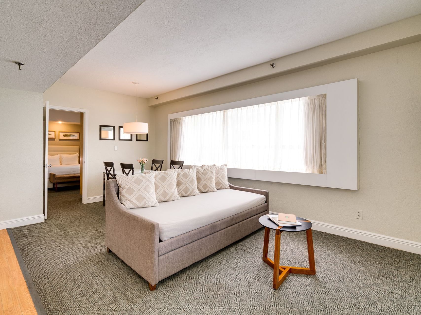 Sofa in the living area of One-Bedroom Suite at Crest Hotel