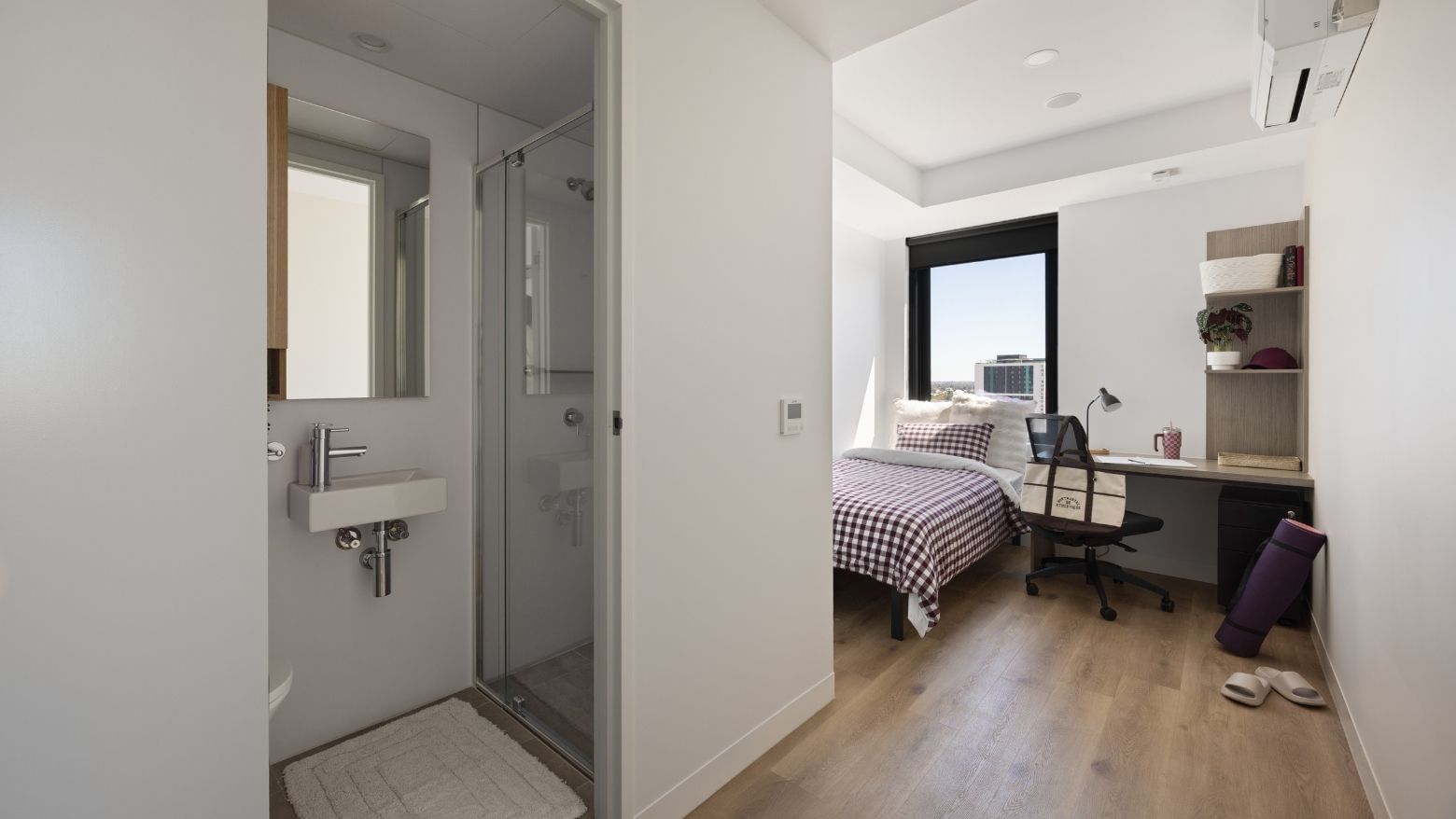 Modern bedroom with desk and bathroom at UniLodge Perth Central.