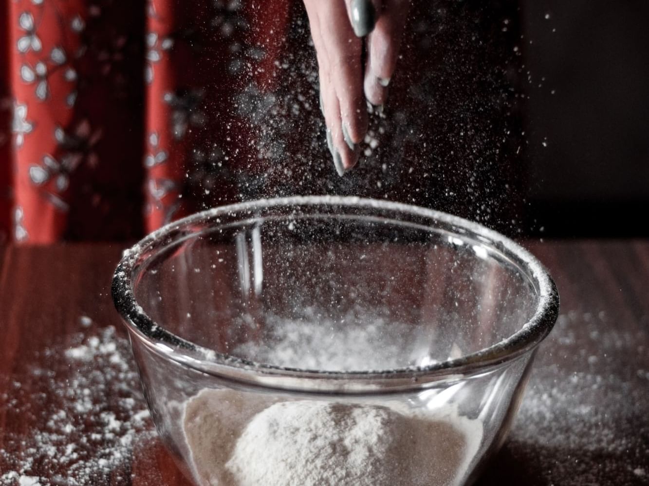 A closeup picture of a flour dough in a bowl