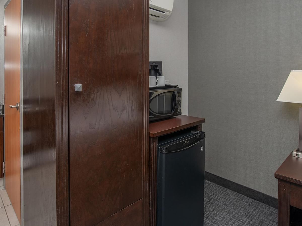 Microwave and mini-fridge in a hotel room.