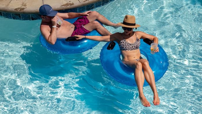 A couple floats along the lazy river at Camp Creek Inn