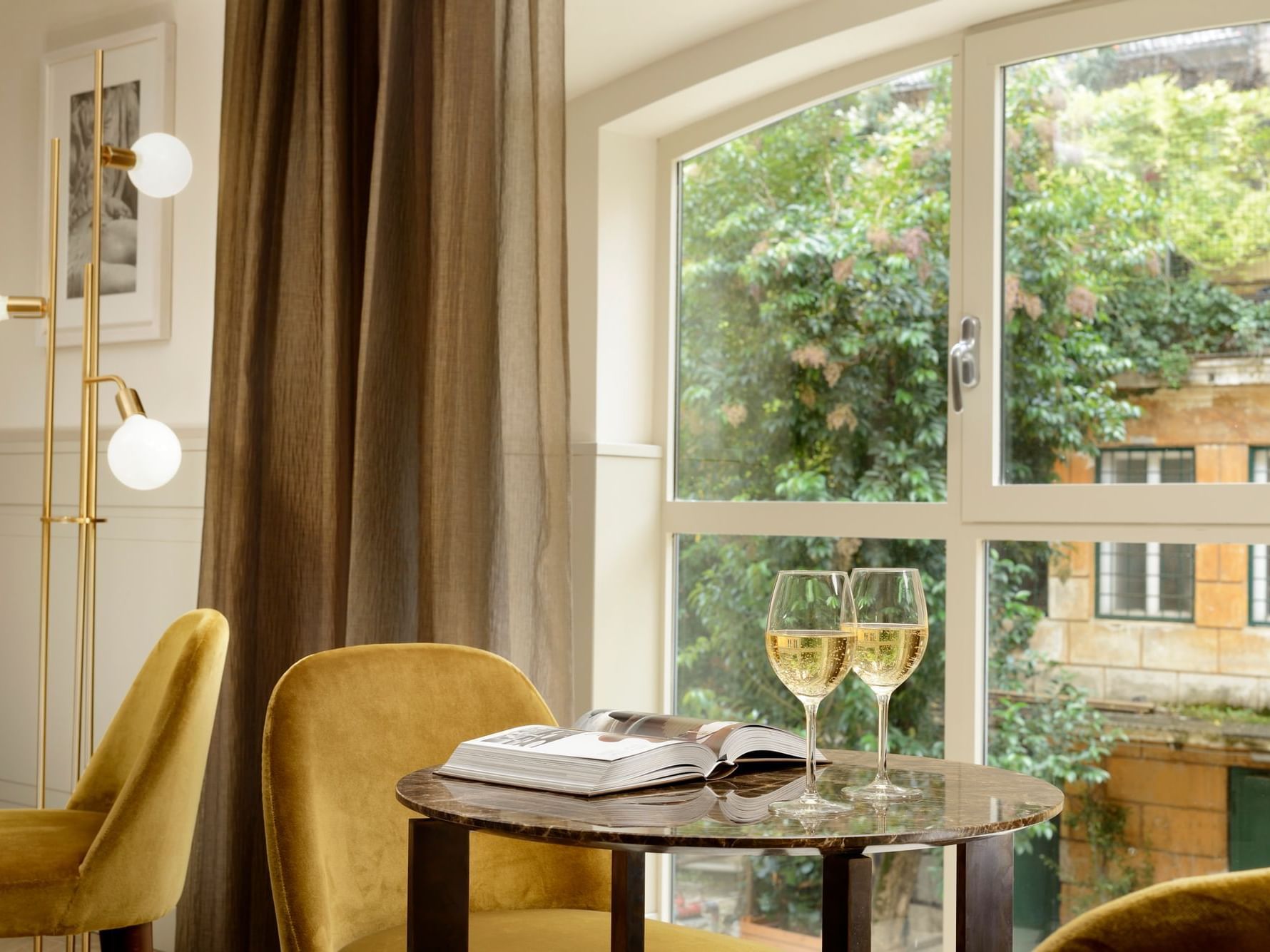 Glasses of Champagne served on a table by the window in Studio Suite at Margutta 54