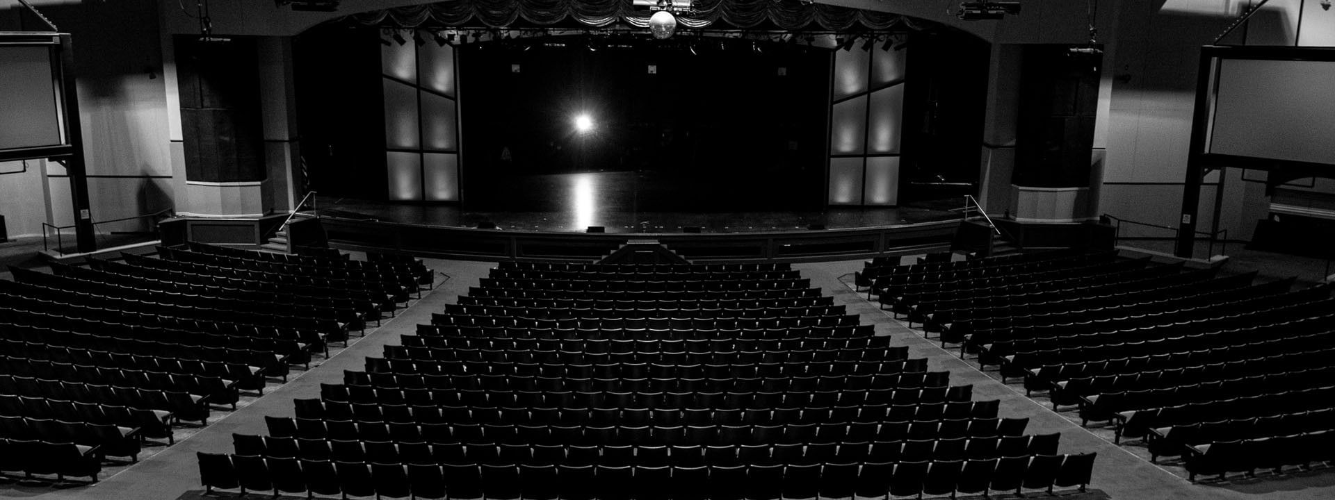 Hillside Theater & Events Center with rows of black seating facing a stage under bright lights at Branson Hillside Hotel