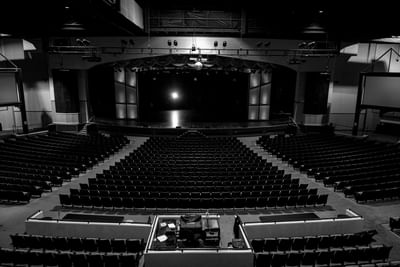 Hillside Theater & Events Center with rows of black seating facing a stage under bright lights at Branson Hillside Hotel