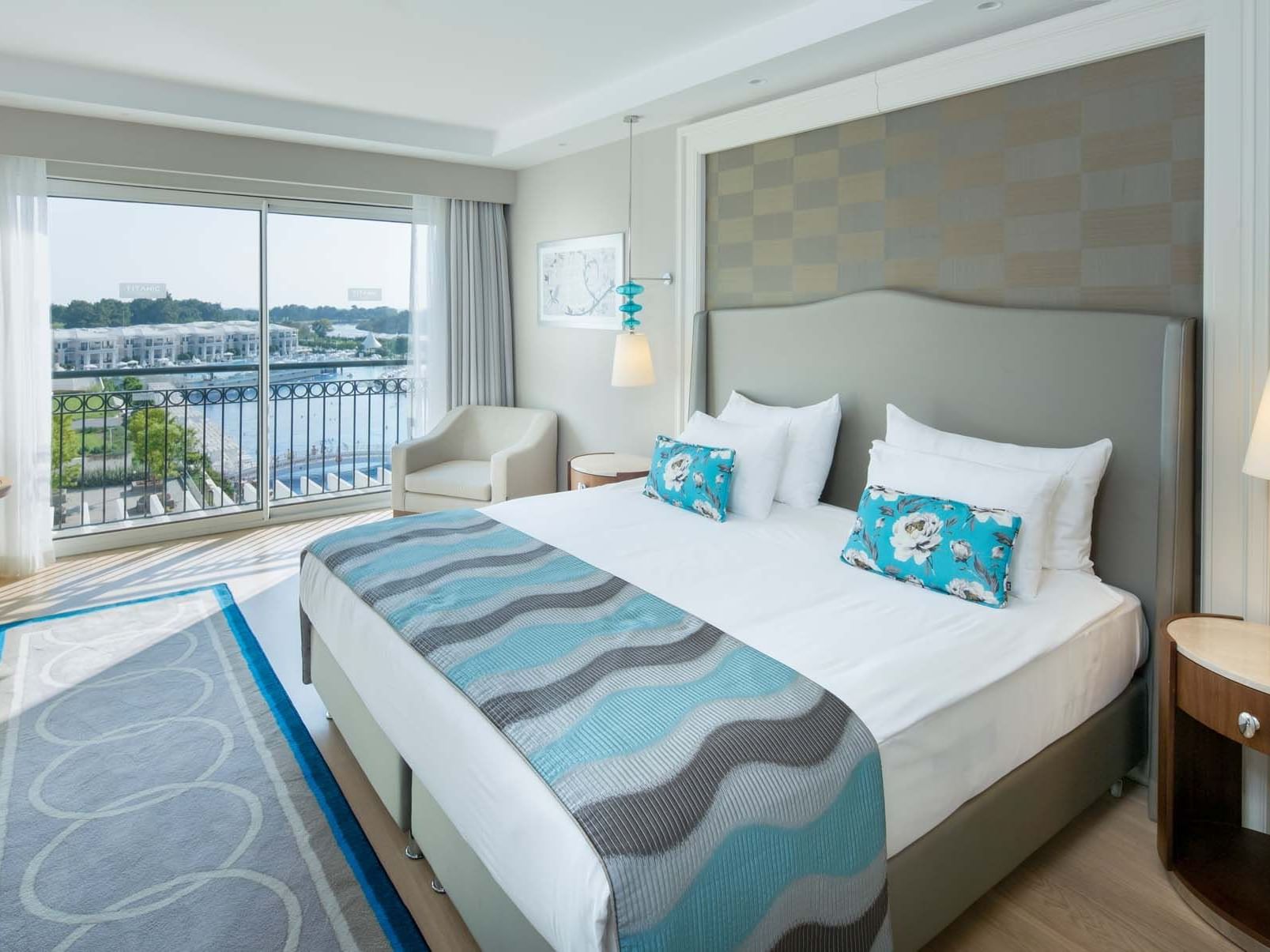 Lounger by the bed in Major Suite with wooden floors at Titanic Deluxe Golf Belek