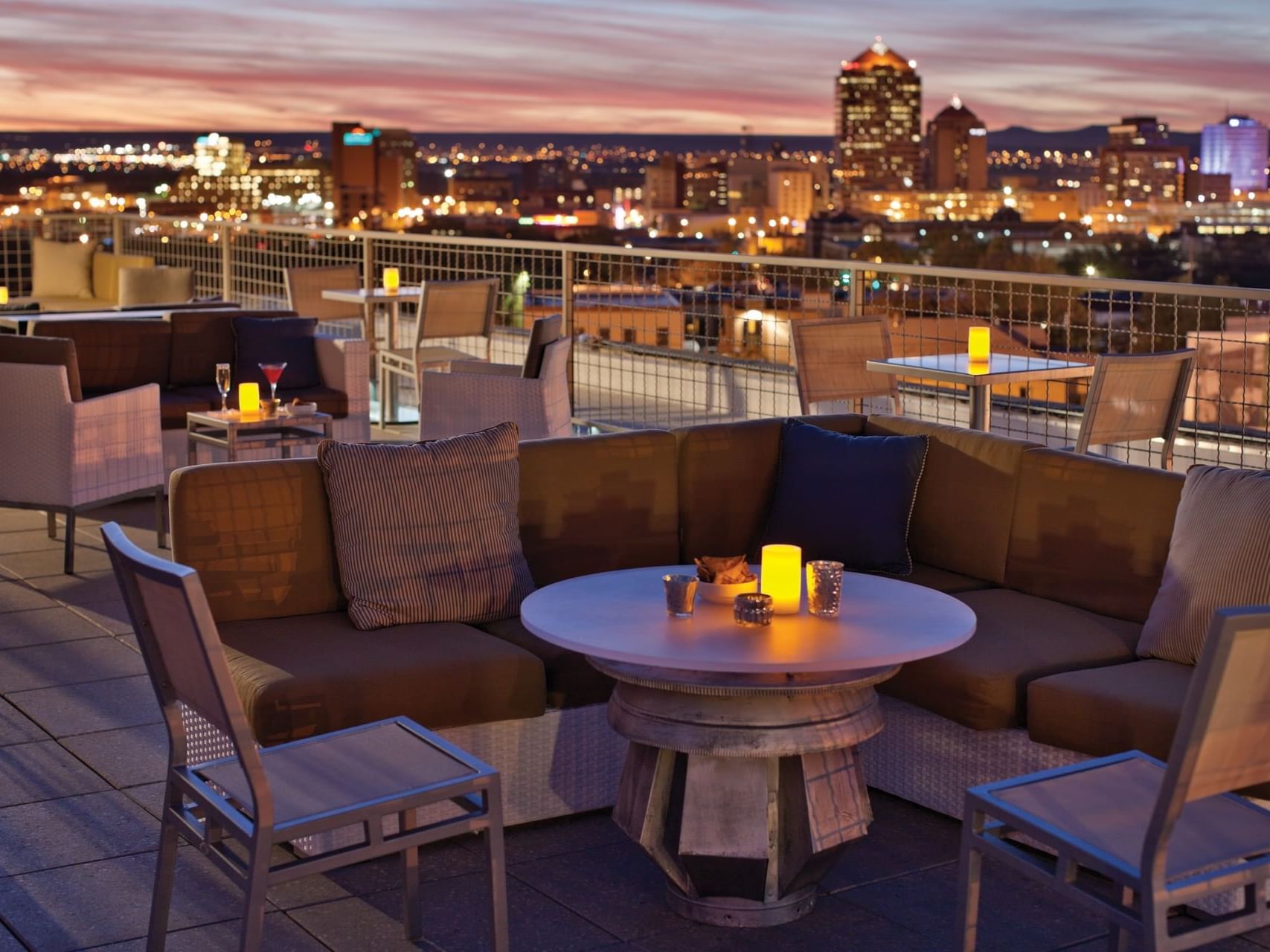 Lounge seats at rooftop restaurant overlooking city