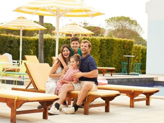 Family with a pleasant smile by the pool at The Magnolia Hotel