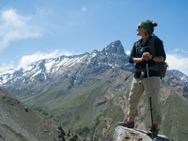 Woman Hiking on mountain top near NOI Puma Lodge Hotel