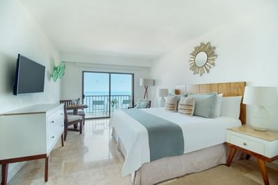 A bright boutique hotel room with two double beds, premium linens, and contemporary furniture.