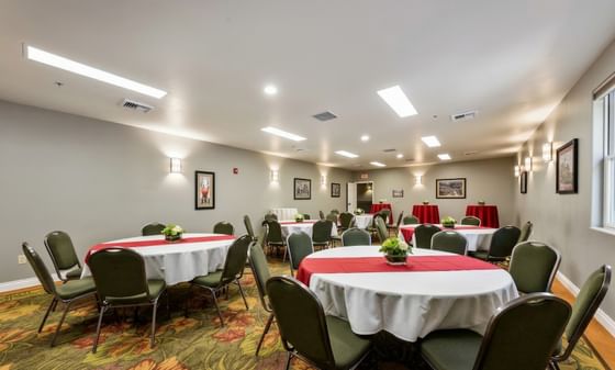 Round tables with chairs in a conference room layout at Oregon Garden Resort, a premier setup for Silverton events