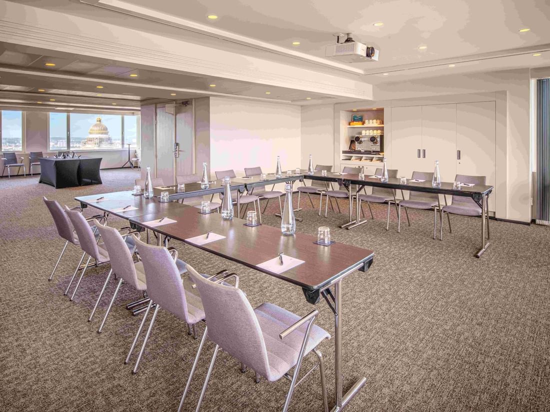 Meet 25 Three Meeting room with tables arranged in a square, and chairs at The Hotel Brussels