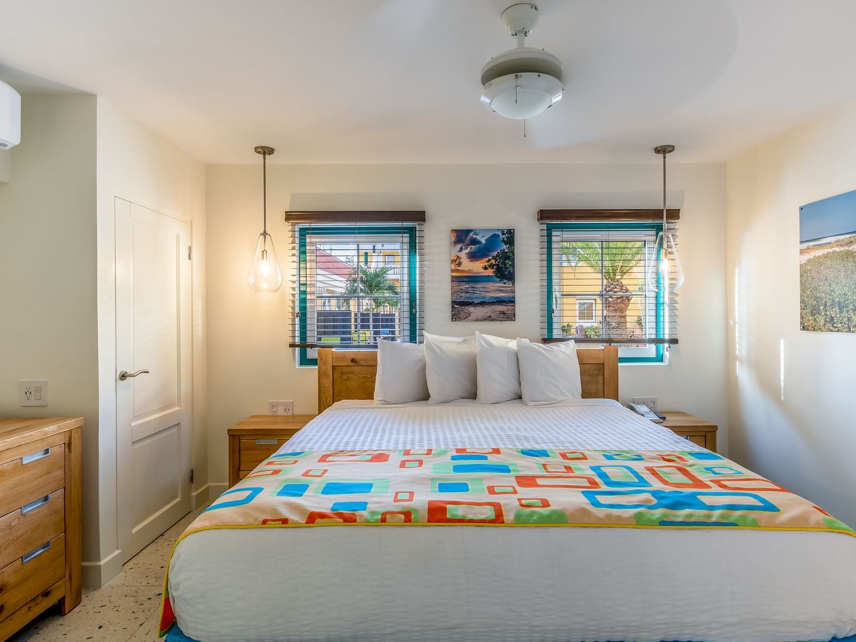 Cozy bedroom with king bed & modern interior in One Bedroom Suite at Passions on the Beach