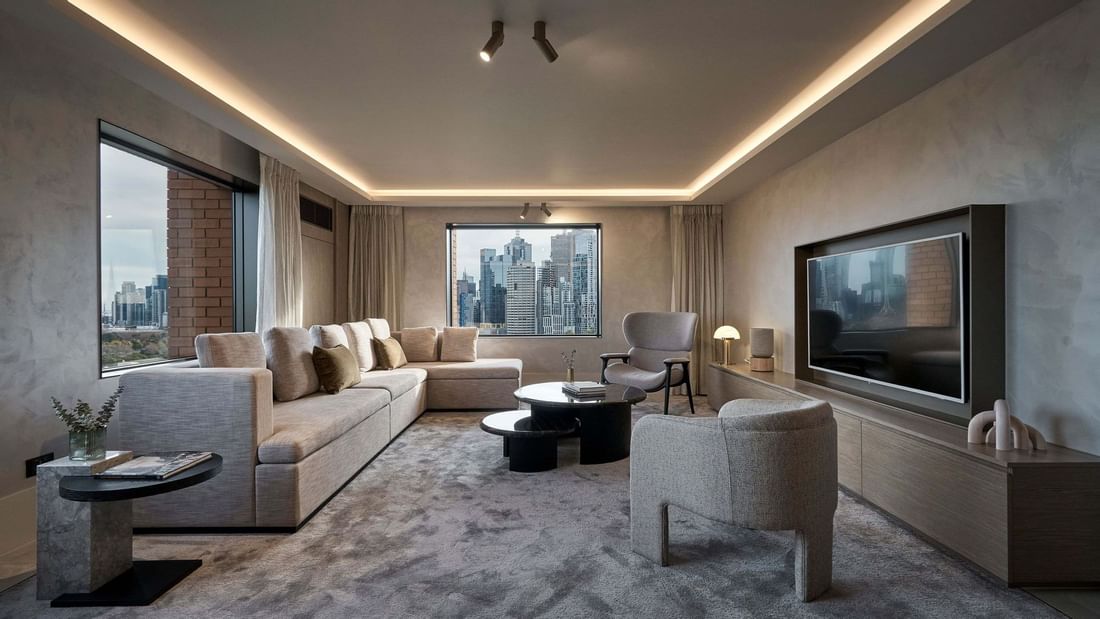 William Clarke Sky Villa living room with city views and modern furnishings at Pullman East Melbourne