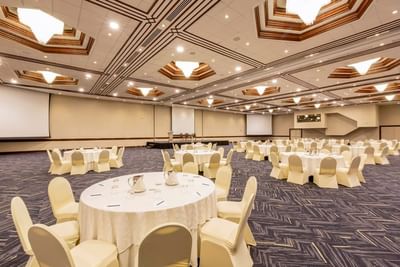 Banquet set-up in the Mediterranean with projector screens and carpeted floors at Hotel Los Delfines & Casino