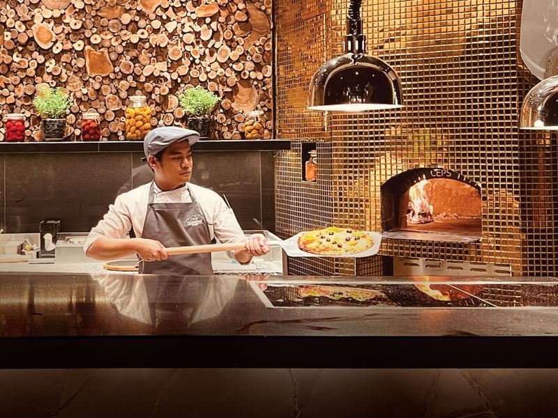 Chef preparing Italian pizza in The Banjaran Ipoh Pizza Dinner at Pomelo Restaurant