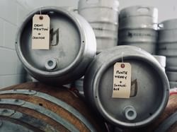 Beer barrels with labels stacked near Quartier Des Marinas