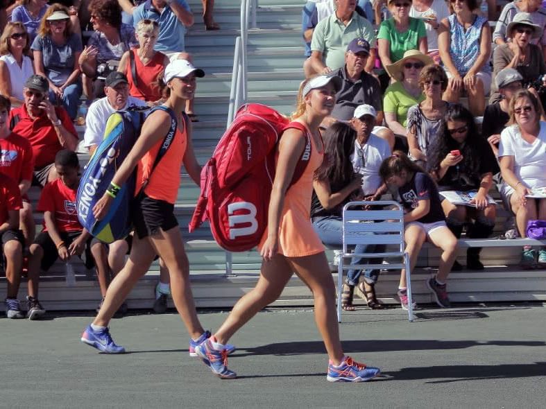 Two tennis players with their bags.