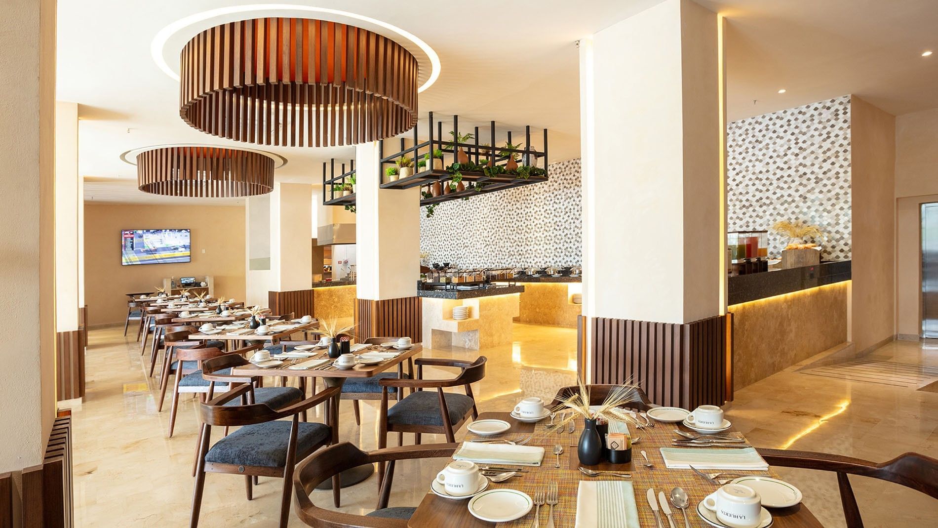 Spacious dining room with contemporary wooden light fixtures in La Huerta at Camino Real Acapulco Diamante