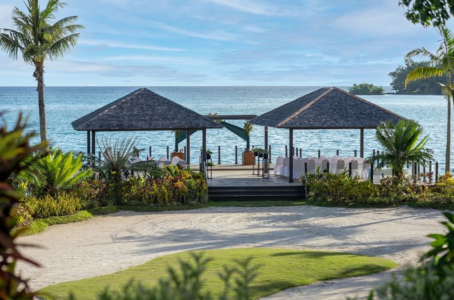 Beachside gazebos with chairs and flowers for an event at Warwick Le Lagon Vanuatu.