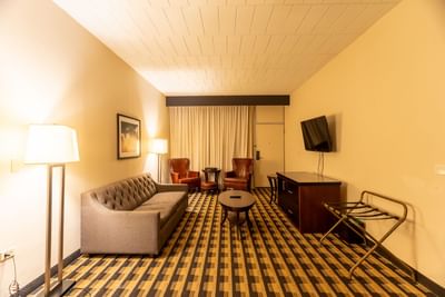 Lounge area with a TV & comfy sofas in King Jacuzzi Suite at M Hotel Buffalo