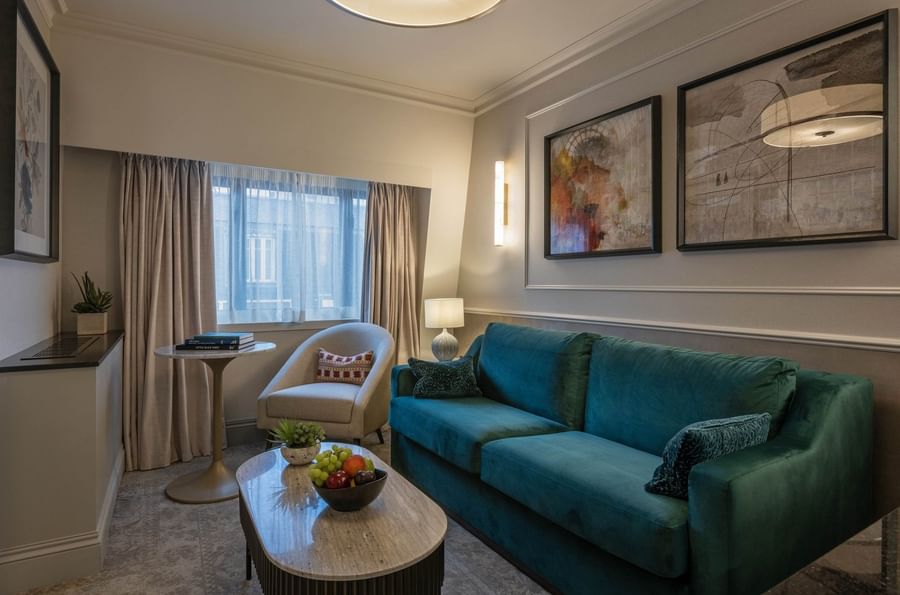 Townhouse Junior Suite living area with plush sofa near window at The Capital Hotel, Apartments and Townhouse