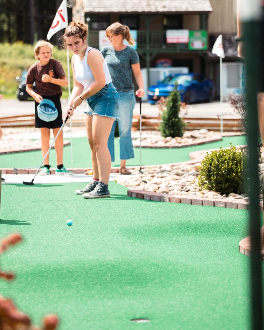 A woman playing golf in the Mini Golf Course at The Inn at Canaan