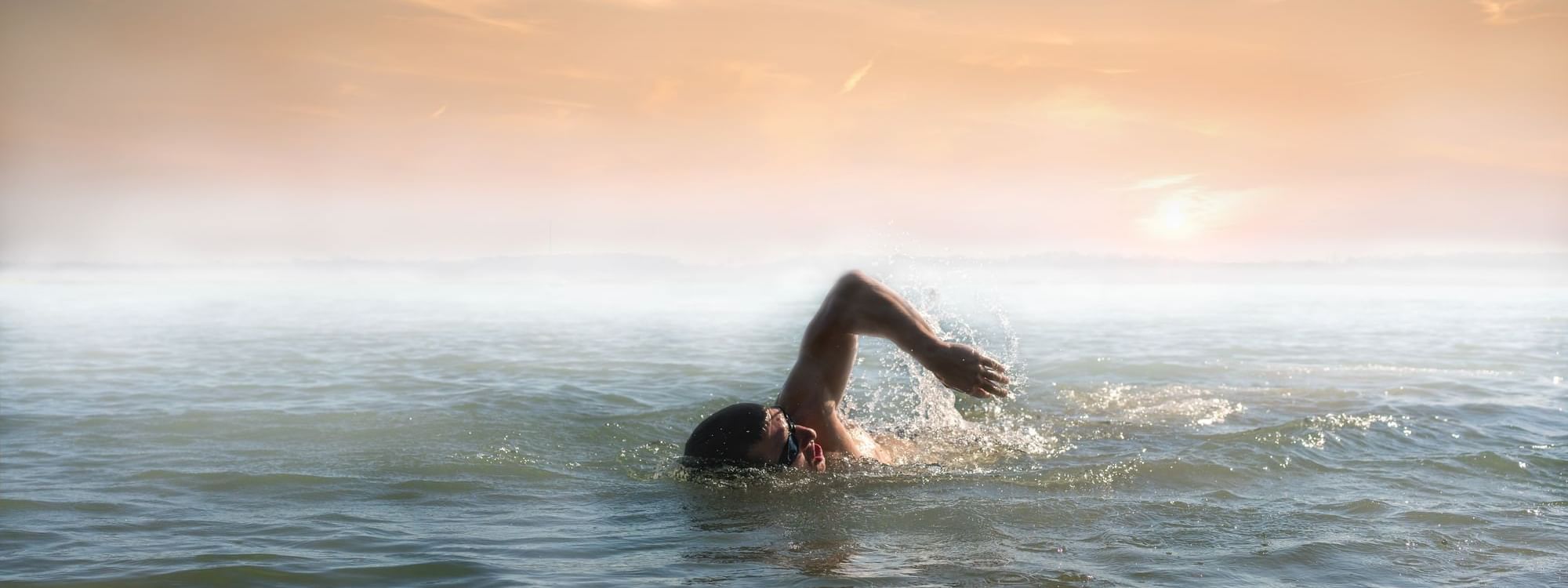 Person swim in open water near Daydream Island Resort