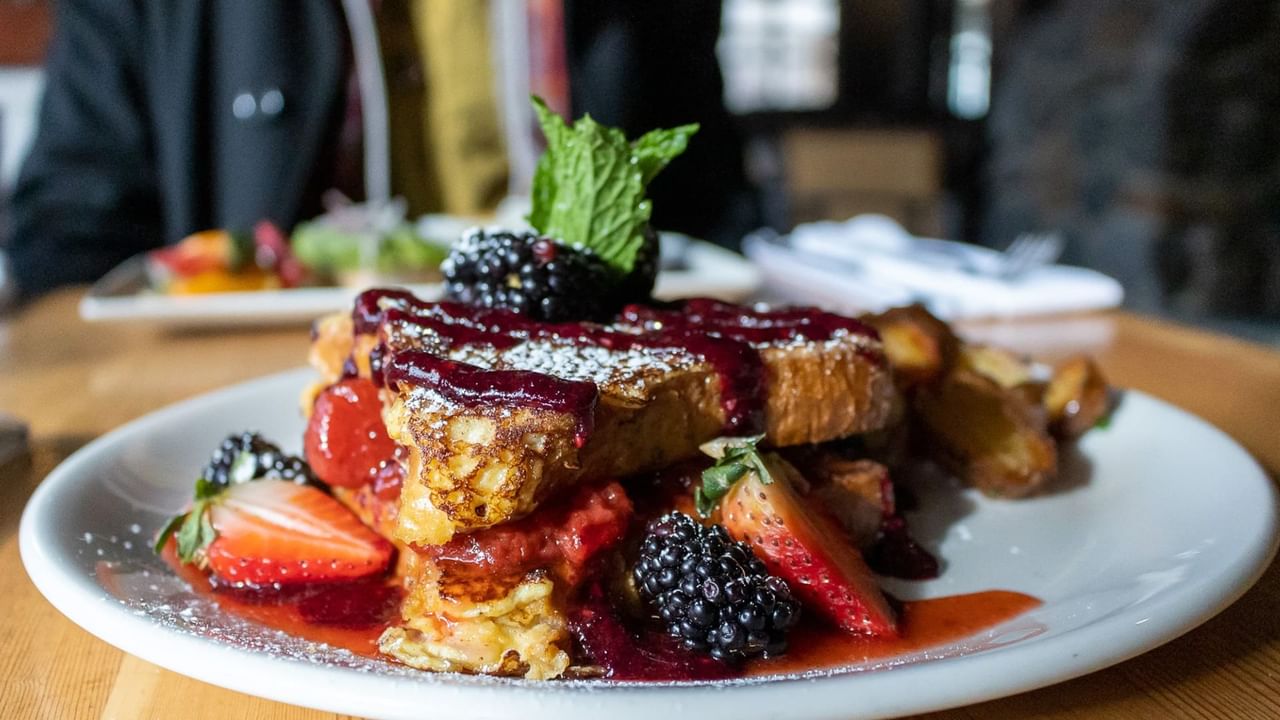 A table full of delicious breakfast items to be enjoyed during a breakfast in Canmore.