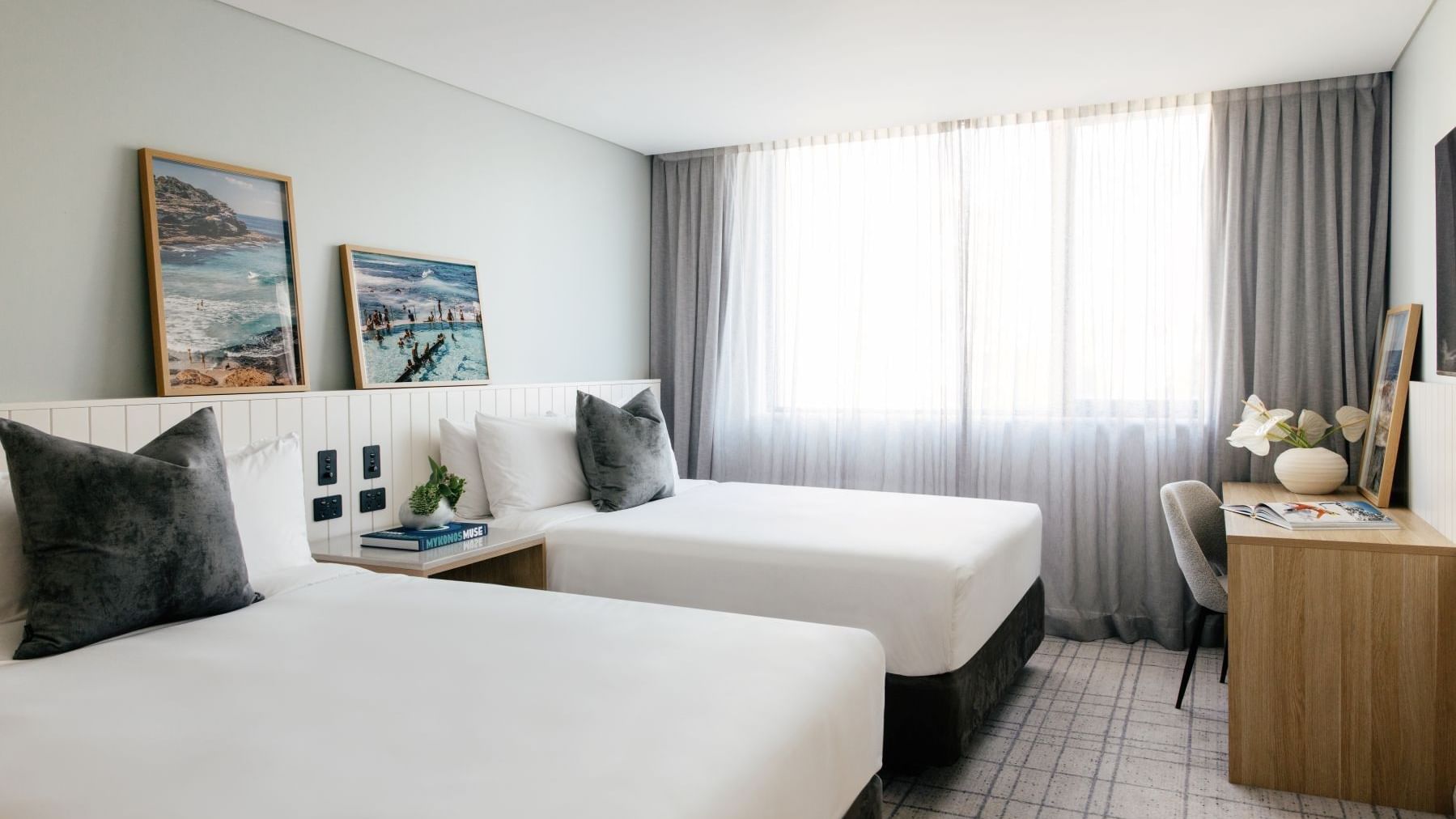 Village Twin at Elysium Manly with cushions by a wooden desk near sheer window curtains, offering cozy Manly accommodation
