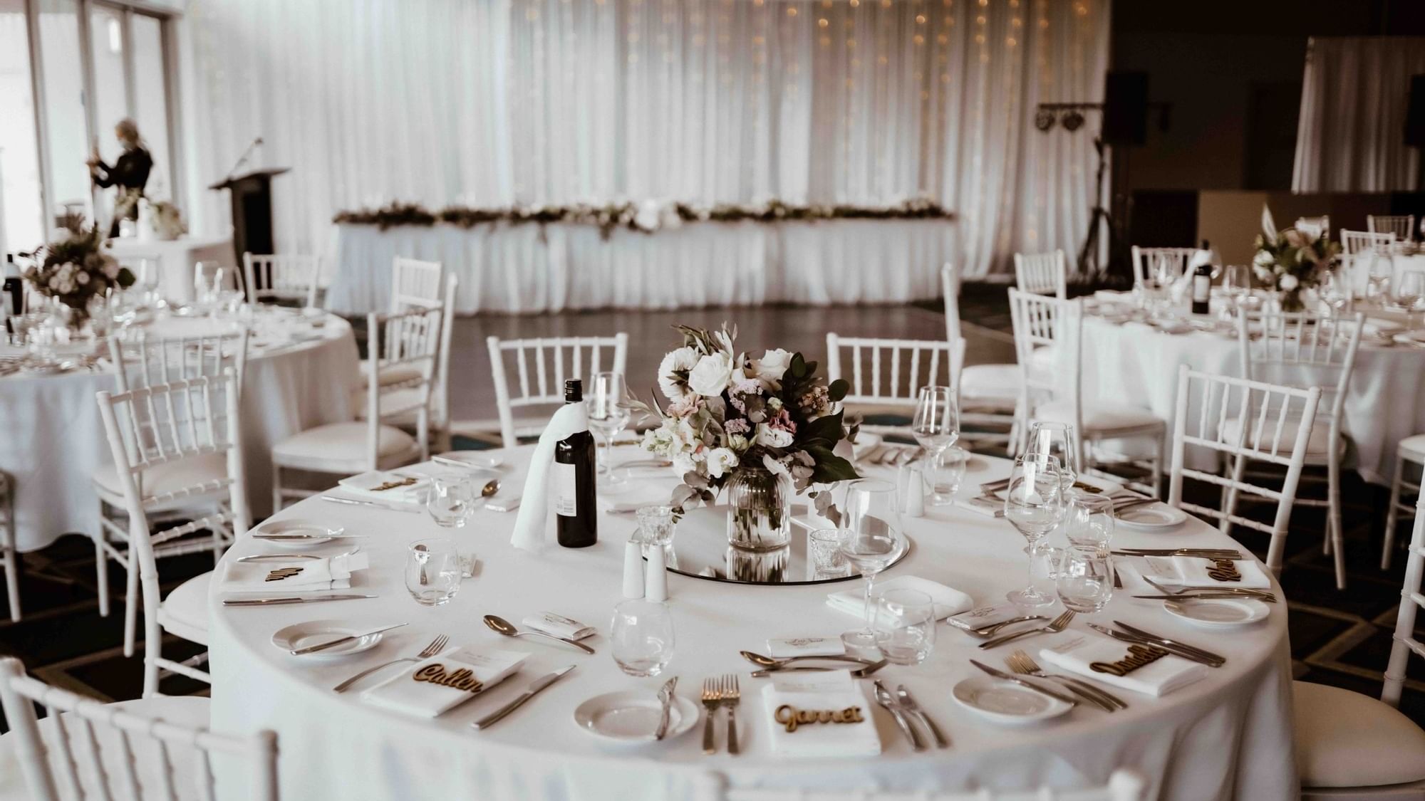 White themed banquet tables arranged for a wedding at Pullman Magenta Shores