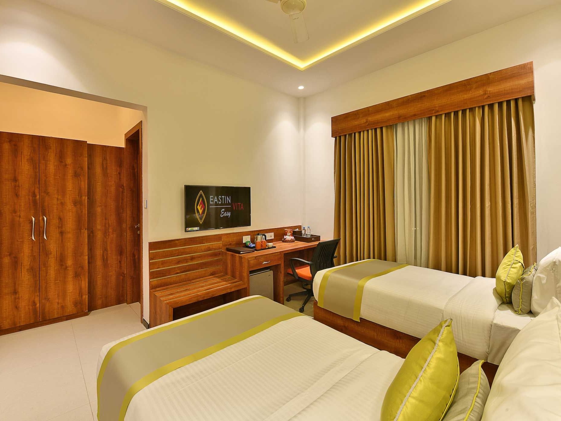 Two beds & workspace area in the Superior Room at Eastin Hotels