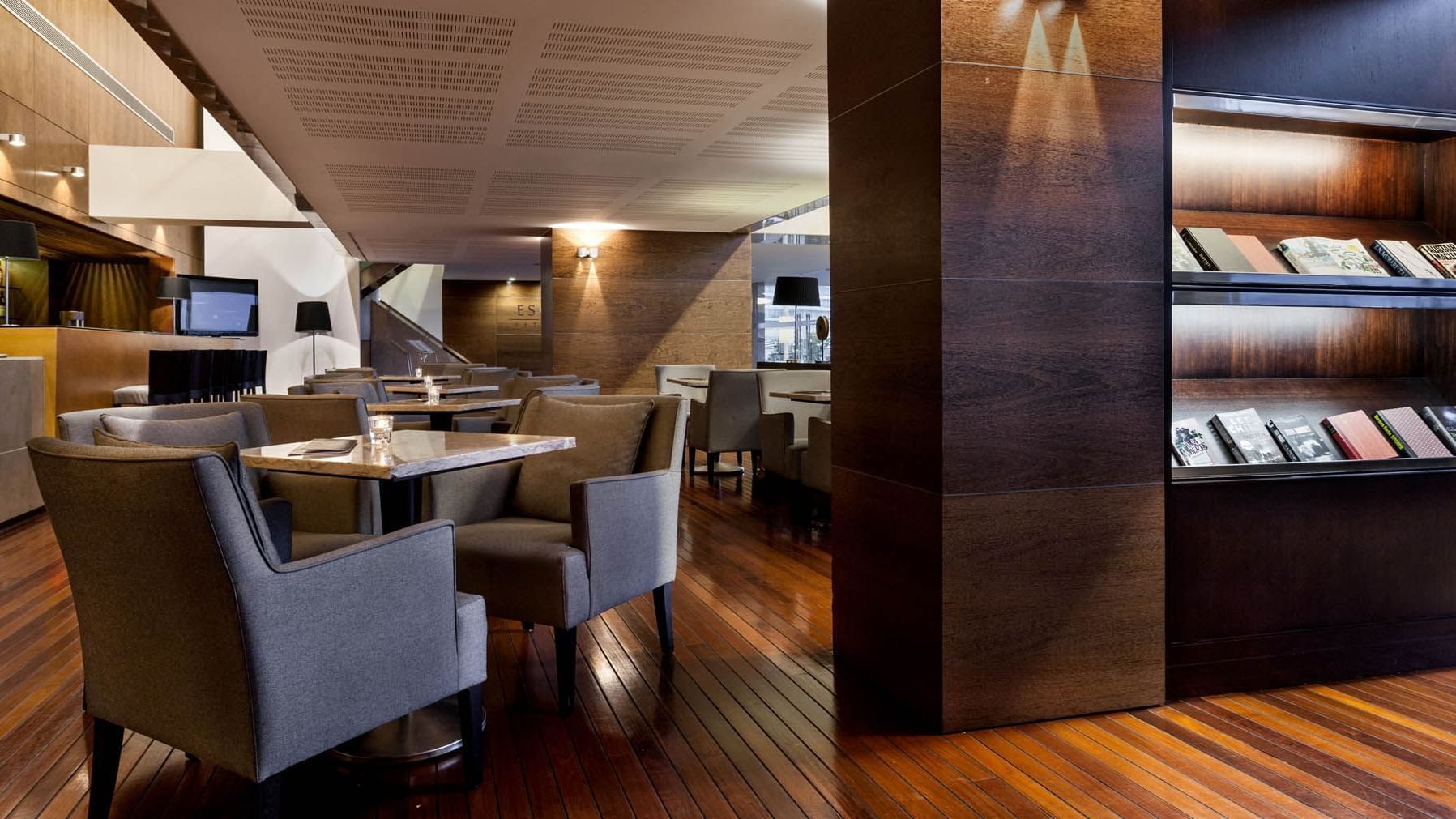 Illuminated dining area of Palhabote bar with wooden floors at Hotel Marina Atlântico