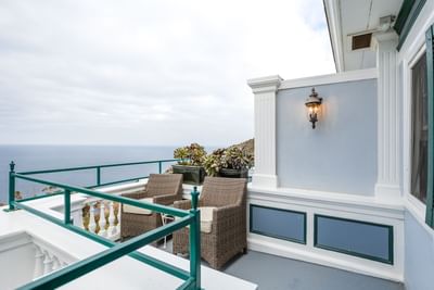 Seaside balcony with wicker chairs and ocean view in Catalina Island suites at Mt Ada