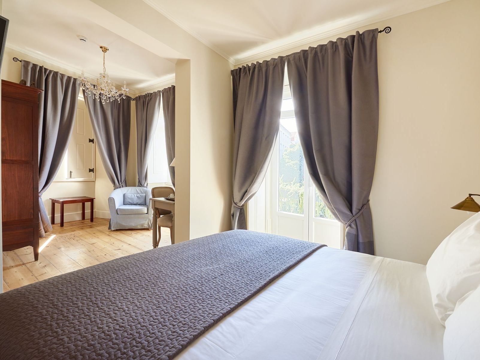 Hotel Alegria room with bed, and accent chairs near window