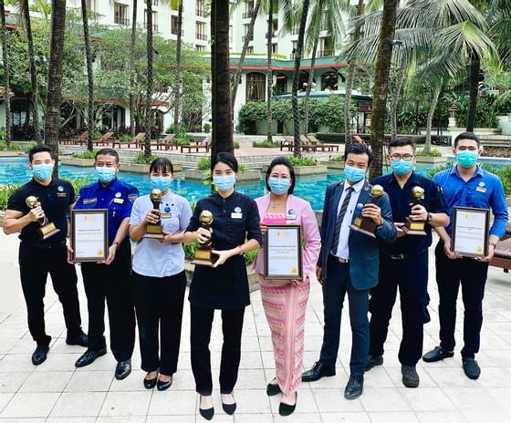 Staff holding awards at Chatrium Royal Lake Yangon