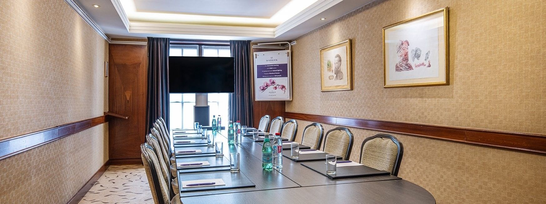 Salle de réunion Mercator avec table ronde et chaises au Warwick Grand-Place de Bruxelles.