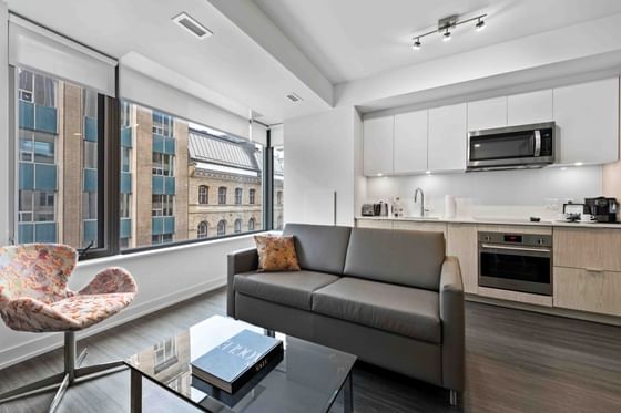 Kitchenette and living area with plush seatings in One-Bedroom Suites at ReStays Ottawa