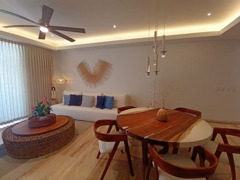 Living area with dining table and comfy sofa in a room at Live Aqua Private Residences La Paz