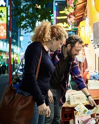couple looking at food in a Japanese market