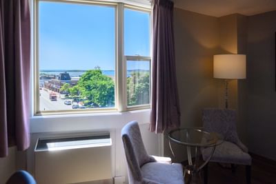 Scenic town and ocean view through a large window from the Standard King room at Rodd Grand Yarmouth