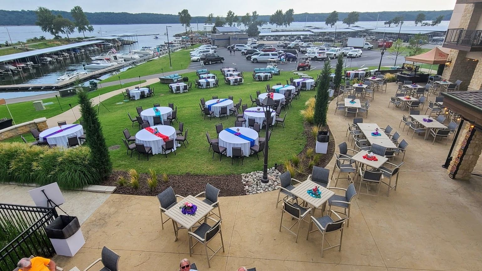 Round tables with colorful floral centerpieces set on a spacious patio at Doc's lower patio, Shangri-La Monkey Island