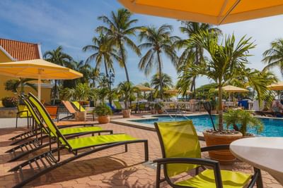 Outdoor pool area with yellow lounge chairs at Amsterdam Manor Beach Resort